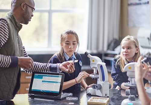 Young girl with HP 360 devices sharing work