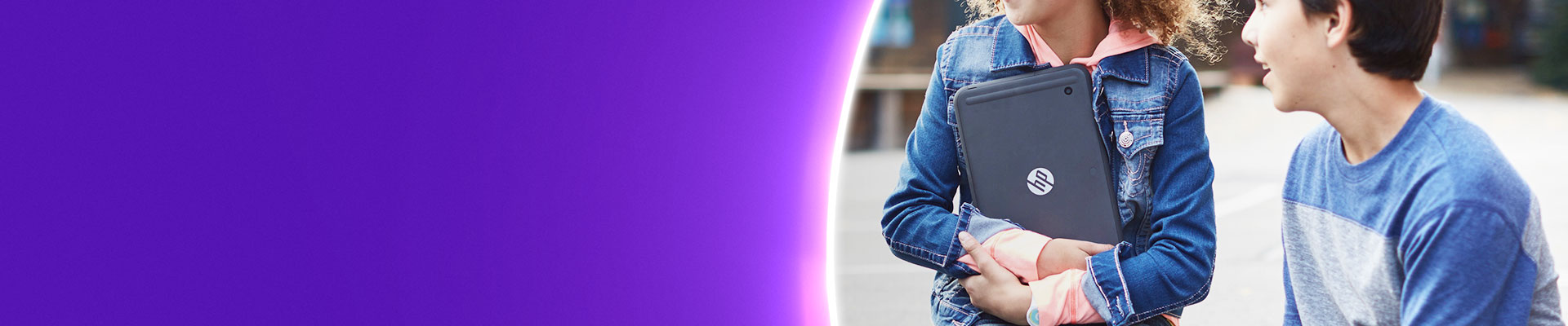Pupil holding HP Tablet in school yard