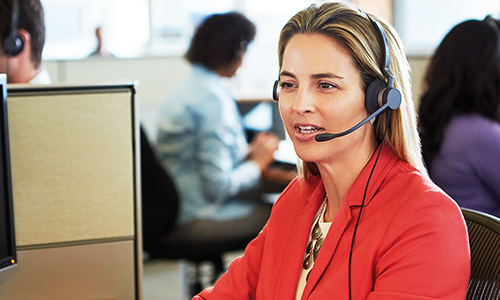 Woman at desk on a call wearing Jabra Biz headset