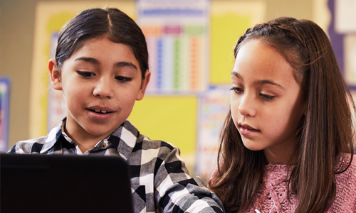 Two students using a windows device