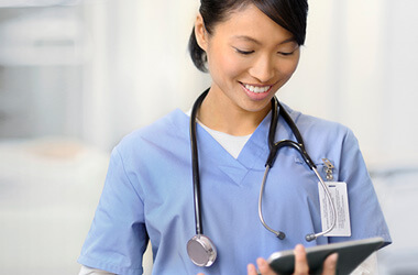 a doctor/surgeon looking at a tablet screen