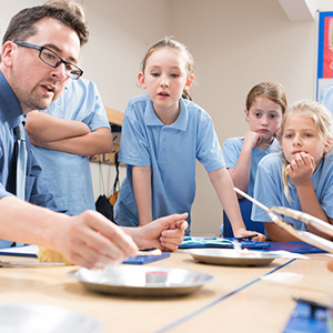 Pupils in a classroom using technology devices