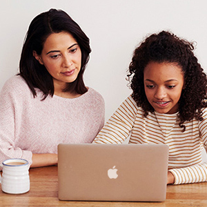 Parent and child working on laptop