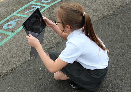 Girl on playground with iPad
