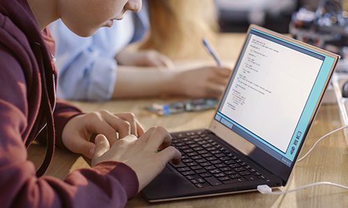 Student in class using laptop with AMD technology