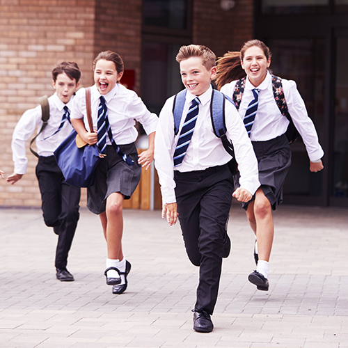 School children running across a school courtyard