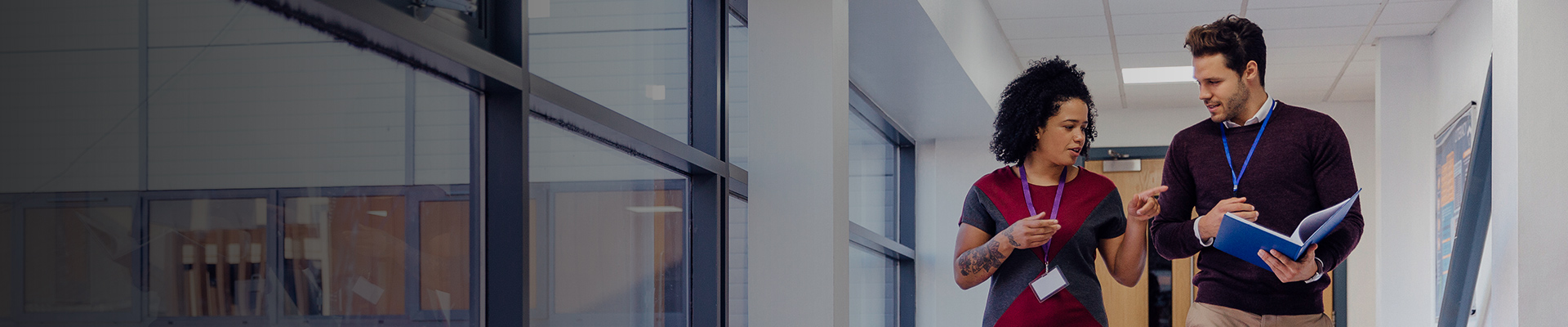 Teachers walking down hallway talking