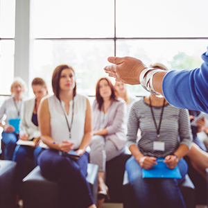 Teacher presenting to university students